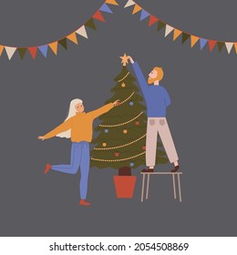 A man and a woman decorate a Christmas tree. New Year or Christmas design.