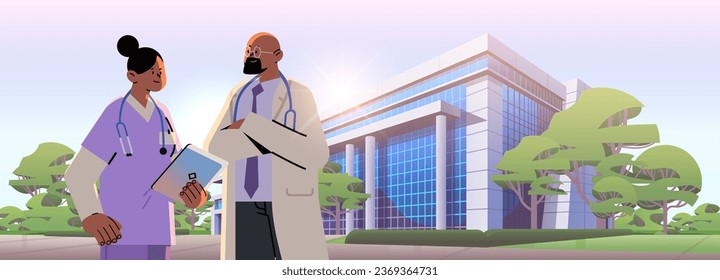 man woman doctors with stethoscopes walking near hospital building medical workers in uniform happy labor day celebration concept