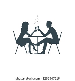 Man and woman drinking wine at a table in a cafe. Black silhouette on white background, vector illustration.