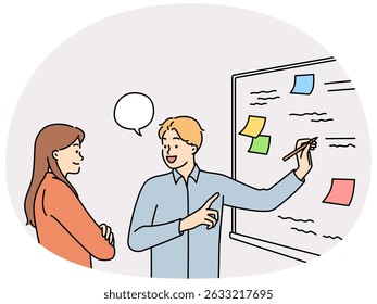 Man and woman employees of startup stand at whiteboard are brainstorming to solve business problems. Colleagues together looking for way to increase company revenue by brainstorming