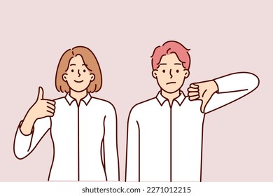 Man and woman give different assessment of upcoming business deal showing thumbs up or down. Two business partners vote with gestures for making strategically important decision or signing contract