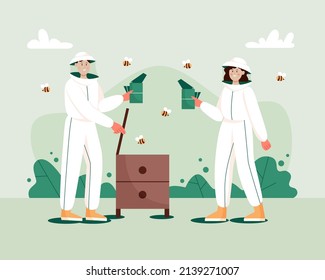 Man and woman in hat and protective uniform with a bee smoker device and beehive. Beekeeping workers in uniforms. Concept of beekeeping.