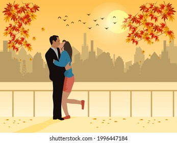 Man and woman kissing in a public garden with city and sunset in the background.