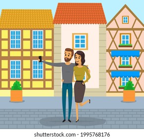 Man and woman making self portrait with mobile phone camera while traveling. Couple with phone is posing for joint photo on background of buildings. People take selfies together during tour in Europe