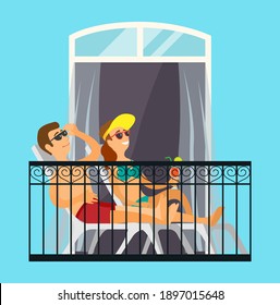 Man and woman married couple sunbathe on the balcony relaxing at home in the sun in bathing suits. Enjoying summer season from balcony of apartment or hotel room. Fun sunbathe activity indoor