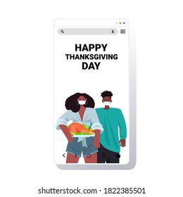 man woman in masks celebrating happy thanksgiving day african american couple holding roasted turkey coronavirus quarantine concept smartphone screen copy space portrait vector illustration