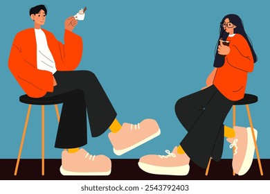 man and woman in modern matching couples outfits. the couple sitting on the chairs and holding cups of coffee