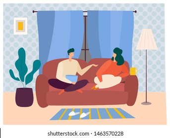 Man and woman rest on the sofa, preparing to watch some movies, having popcorn and drinks. Sweet home relaxing. Family time together.
