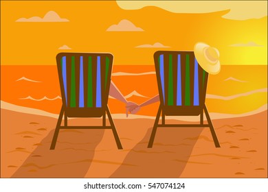 Man and woman sit in beach chairs on the beach and holding hands