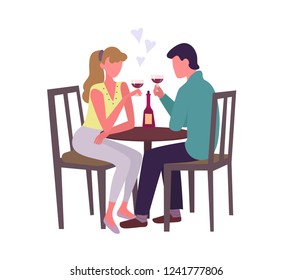 
A man and a woman sit at the table and drink wine. Romance, dating or vacation.