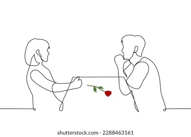 man and a woman sit at a table opposite each other on the table lies a red rose - one line drawing vector. date concept, blind date