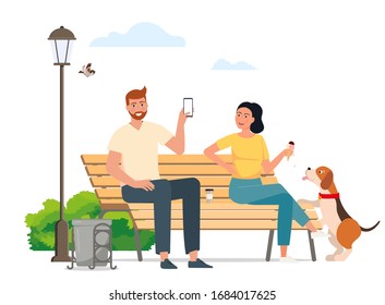 Man and woman sitting on a bench chatting in a park