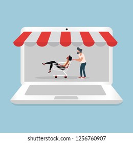 man and woman sitting in shopping cart with Online shopping laptop