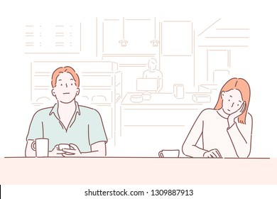 A man and a woman are sitting side by side in a cafe.