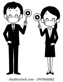 A man and a woman in suits wearing masks holding the correct tags.