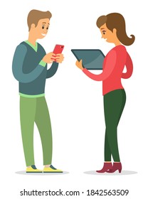 Man and woman talking to each other. Man is holding a mobile phone in his hands and looking at the screen, smiling woman is holding electronic tablet. Communication of people. Staff conversation