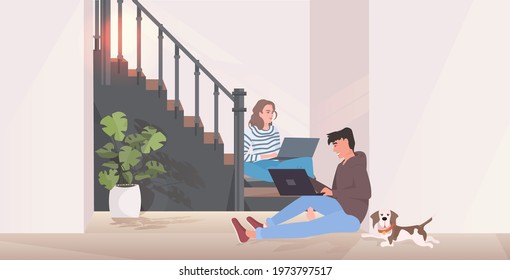 man woman using laptops couple sitting on staircase spending time together modern hallway interior