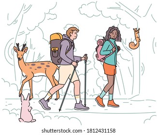 A man and a woman are walking on a forest path with backpacks. Forest animals are watching them. hand drawn style vector design illustrations. 