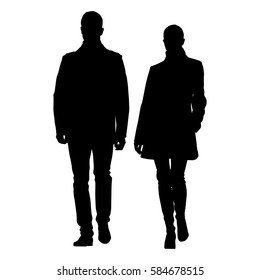 Man and woman walking side by side dressed in coats. Vector silhouette of young couple well dressed people