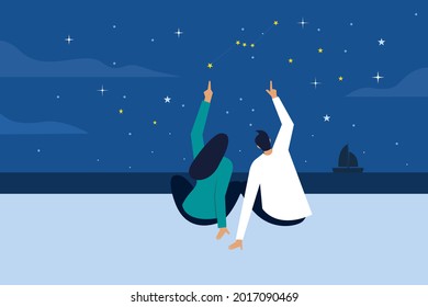 Man and a woman watching stars in a beach at night