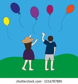 Man and woman wave their hands to flying balloons