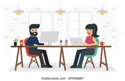 Man and woman working in coworking space.