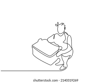 a man working in a factory at a job is holding a large box