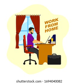 A man working with his computer at home, to do work from the office during the coronavirus pandemic.