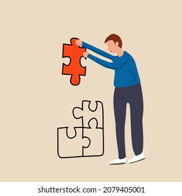 A man is working at a jigsaw puzzle.  Business solutions, success and strategy concept.