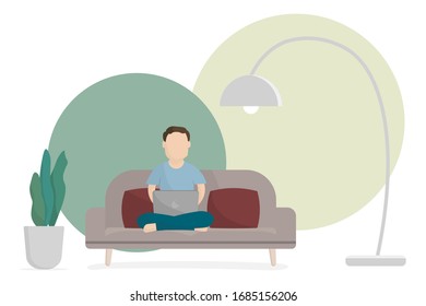 Man working with laptop on sofa at home. Work from home concept.