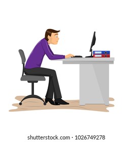 A man is working in the office at the computer.