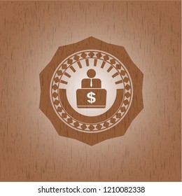 man working on computer icon inside badge with wood background