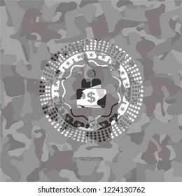 man working on computer icon inside grey camouflaged emblem