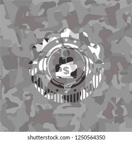 man working on computer icon inside grey camouflaged emblem