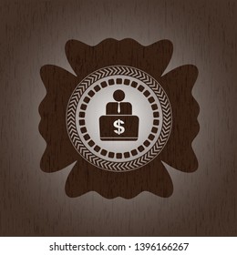 man working on computer icon inside badge with wood background