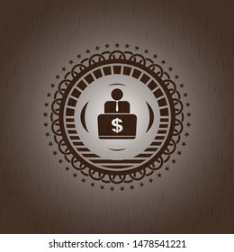 man working on computer icon inside wood emblem
