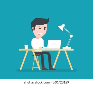 Man working on desk with laptop coffee and lamp.