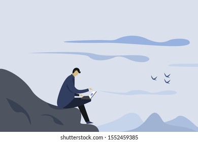 A man working on his laptop in a hilly outdoor