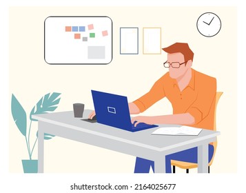 A MAN WORKING ON LAPTOP