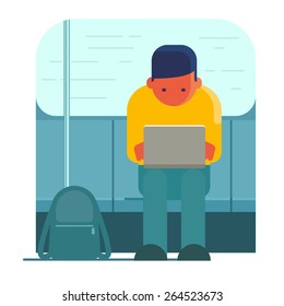 Man working on laptop in public transport
