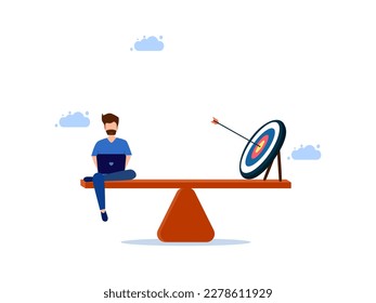 man working on laptop with target on scales. Balancing work and achievement goals