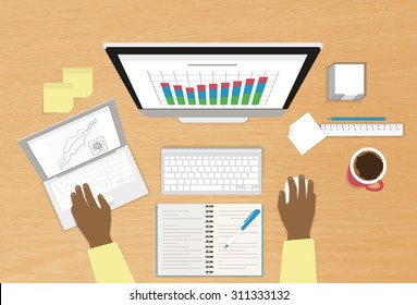 Man is workking at his workplace using computer and laptop