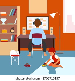 A man works from home at a computer.  son is playing cars behind him.