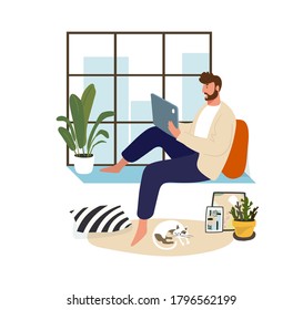 A man works at home on a laptop sitting at the window. Home office and remote work. Freelance guy, online training. Flat vector illustration. Male character in a modern cozy interior