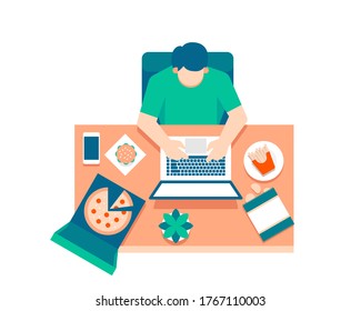 A man works on a laptop from top view surrounded by foods and snacks