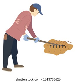 A man works a rake in the garden. A cheerful man loosens the land for planting plants. Concept: soil leveling, cultivation, work in the fresh air, hardworking guy, spring work, caring for the planet.