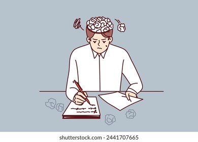 Man writer writes story for own book, sits at table with crumpled papers instead of brain. Young guy is writer inspired to create own literary novel or series script with sharp plot twists