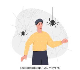 A man in a yellow sweater surrounded by hanging spiders and web designs on a light background. Concept of fear of spiders. Vector illustration