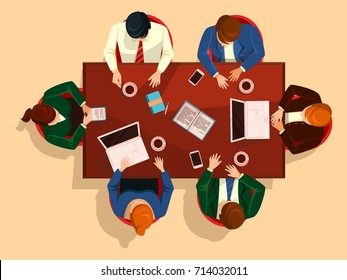 Manager team meeting at table or desktop. Top view on manager group who are doing brainstorming teamwork with coffee and laptop, notebook and smartphone on desk. Negotiation theme