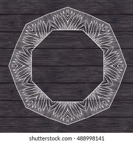 Mandala frame on the wooden background. White outline mandala.